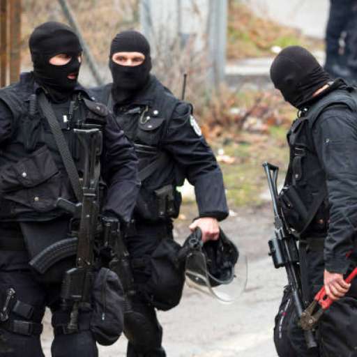 istockphoto-1076802930-612x612-1 Special law enforcement unit. Special police force units in uniforms, bulletproof vests, firearms and guns. Masked police officers. Special Assault Team during mission. Three persons.
